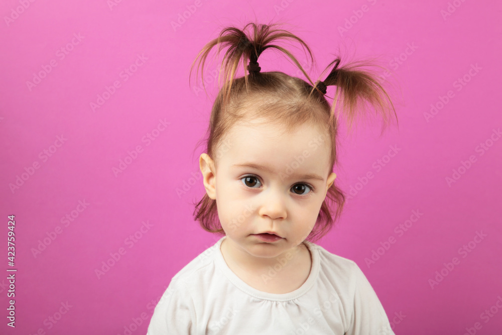 Caucasian little girl looking at the camera with adorable smile, posing on pink. Happy childhood concept Caucasian little girl looking at the camera with adorable smile, posing on pink. Happy childhood concept