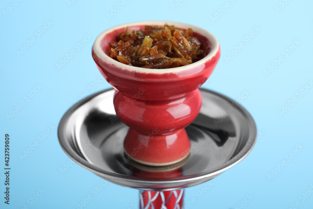 Modern hookah with tobacco on light blue background, closeup Modern hookah with tobacco on light blue background, closeup