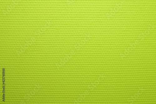 Painted in lime color wallpaper with a texture of large matting