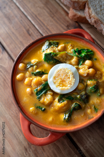 Traditional Spanish cuisine dish that is eaten mainly during the Holy Week holidays. Chickpea, cod, spinach and egg soup. Vigil Potaje. photo