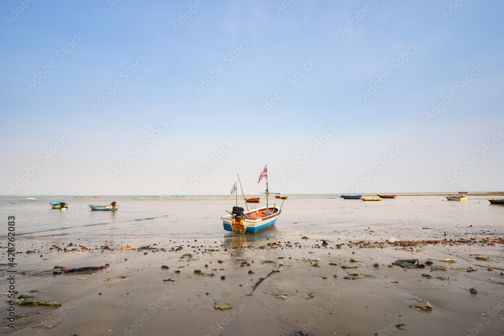 The local long-tailed boats of Thai fishermen are moored on the coast.
