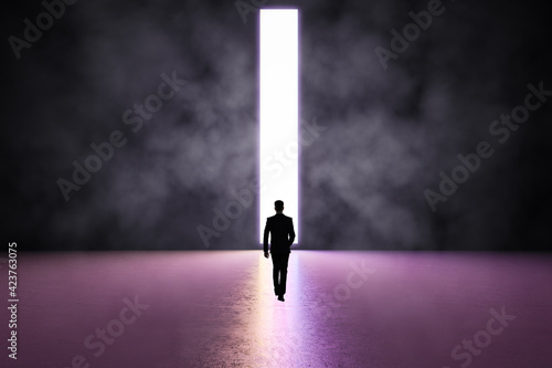 Future concept with black man silhouette heading on glossy purple shades concrete floor to white glowing door hole in dark wall. Mockup