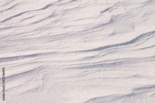 texture of fresh white snow, with a zigzag pattern from the wind