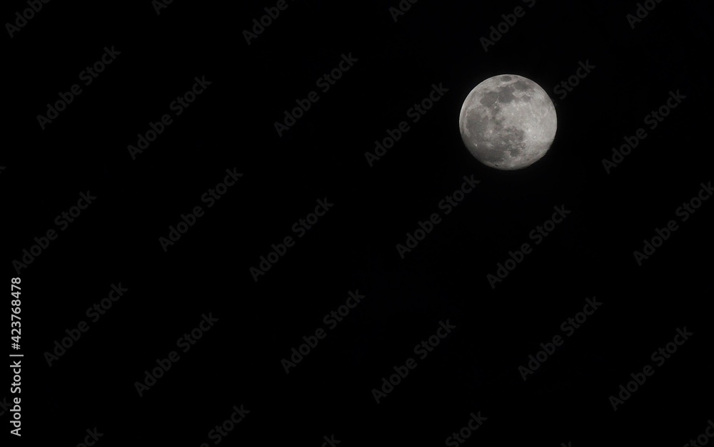 Full moon on black sky. Black and white photo Full moon on black sky. Black and white photo