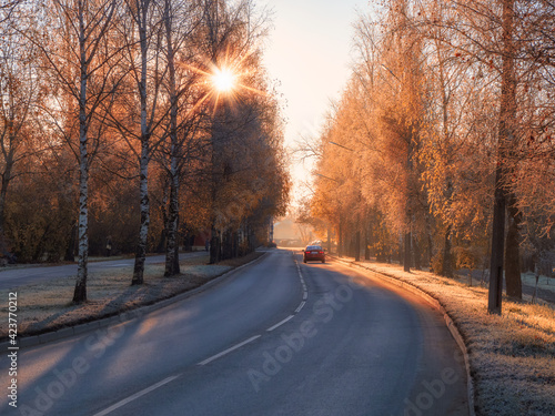 he street of the city in autumn sunny frosty day. Cars on autumn street. © sablinstanislav