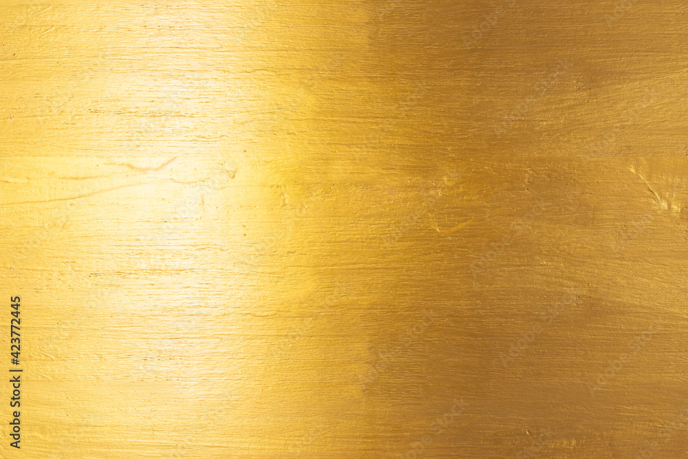 Gold texture background with yellow foil luxury shiny shine glitter sparkle of bright light reflection on golden surface Gold texture background with yellow foil luxury shiny shine glitter sparkle of bright light reflection on golden surface