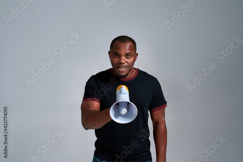Happy african american man with loudspeaker