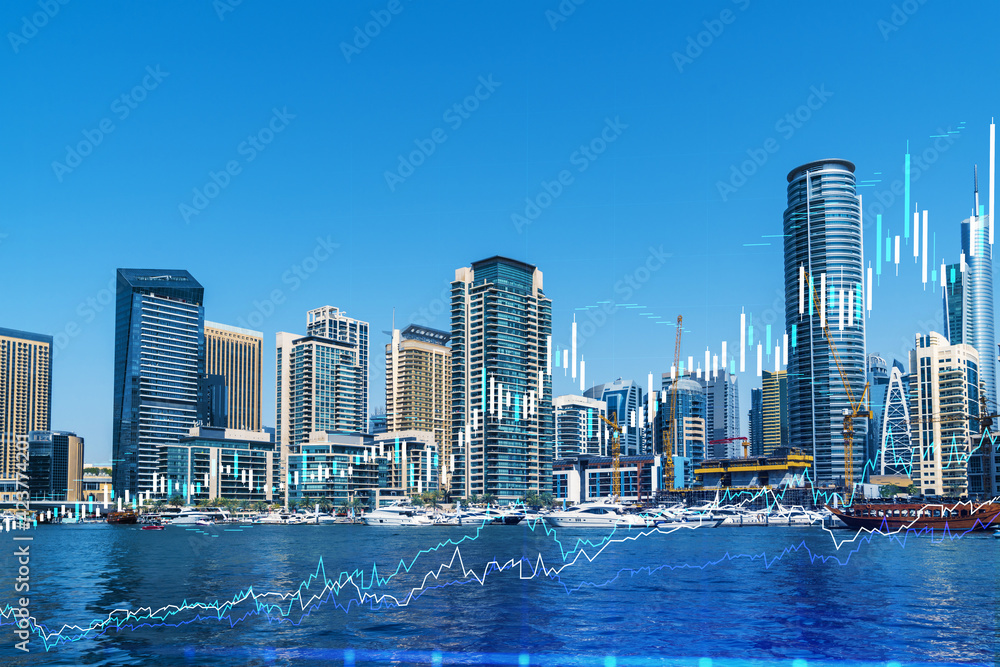 Fototapeta premium Skyscrapers of Dubai business downtown. International hub of trading and financial services of Western Asia. FOREX graph and chart concept. Double exposure. Dubai Canal waterfront.