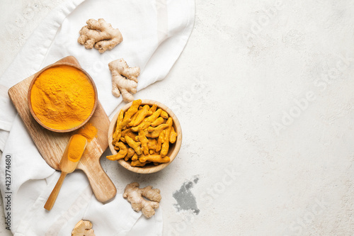 Composition with turmeric powder on grunge background photo