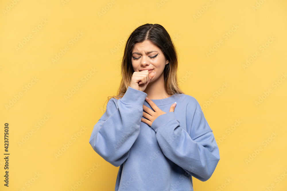 Young Russian girl isolated on yellow background coughing a lot Young Russian girl isolated on yellow background coughing a lot