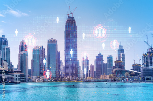 Skyscrapers of Dubai business downtown. International hub of trading and financial services. Social network icons hologram, concept of people connection. Double exposure. Dubai Canal waterfront. © VideoFlow