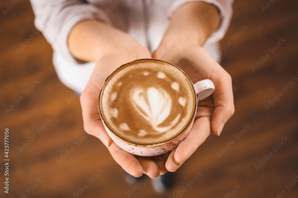 Woman with cup of latte in cafe Woman with cup of latte in cafe