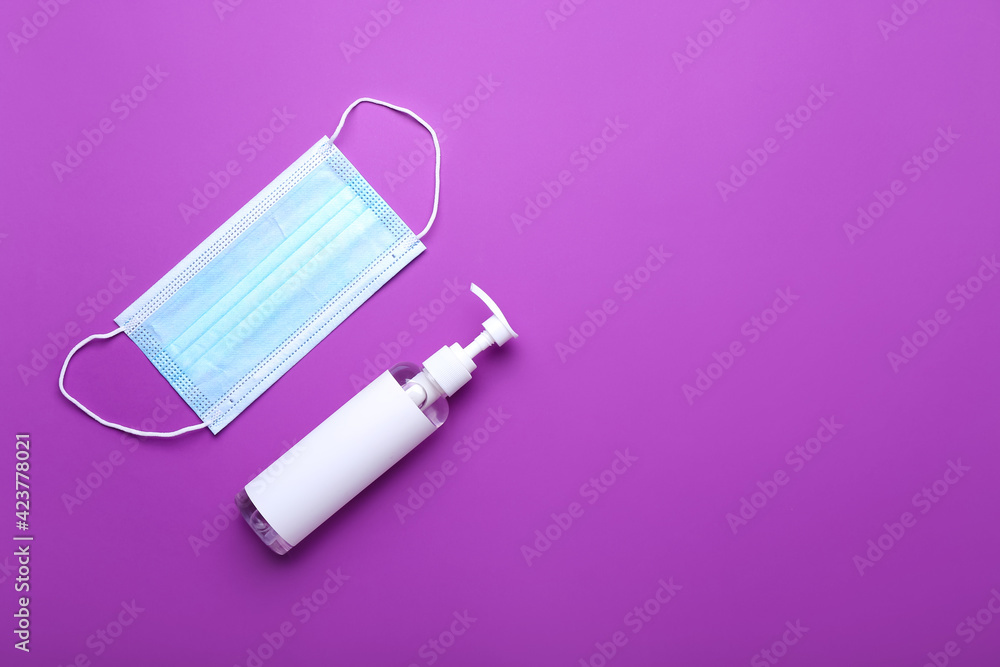 Medical mask and antiseptic on color background Medical mask and antiseptic on color background