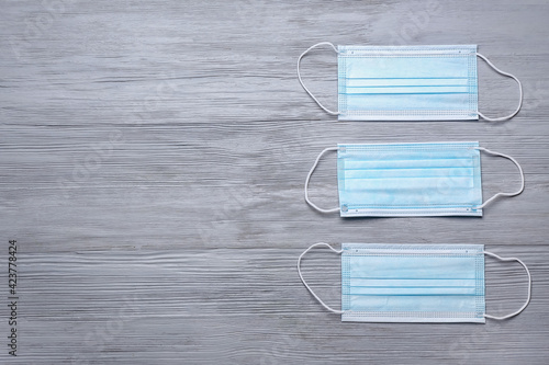 Medical masks on wooden bac...