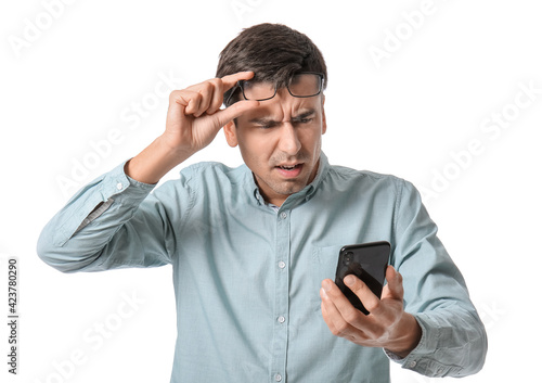 Stressed young man with mob...