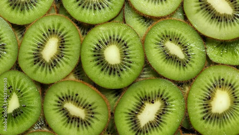 A lot of sliced Kiwi rotating. Ripe Tropical fruits closeup A lot of sliced Kiwi rotating. Ripe Tropical fruits closeup