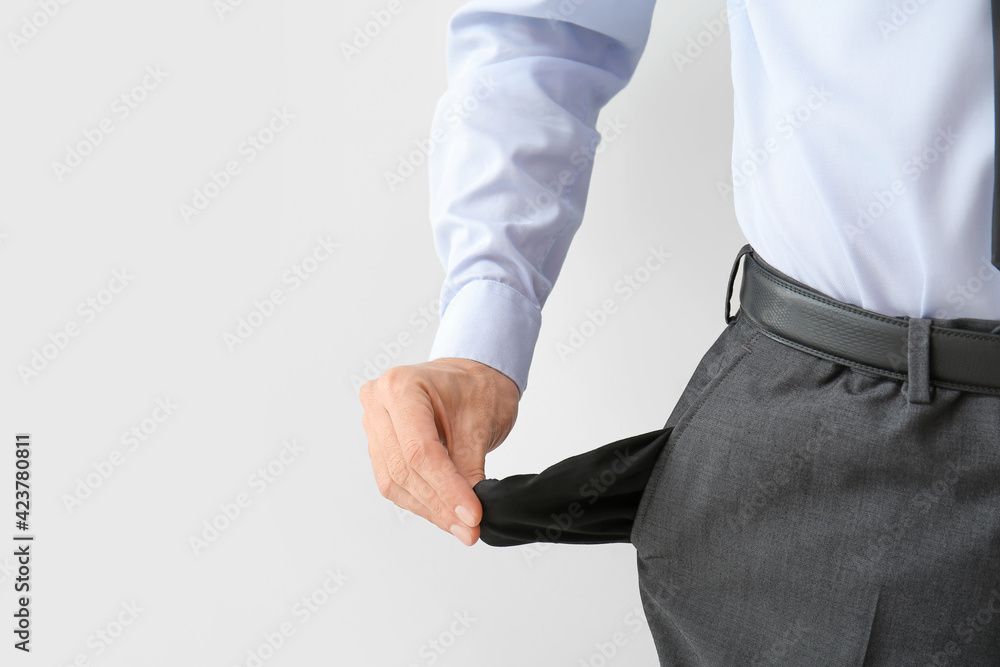 Businessman with empty pockets on white background, closeup. Bankruptcy concept