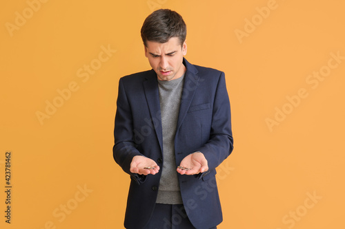 Sad businessman with coins ...