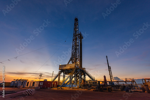 Billede på lærred Land drilling rig in oil field during sunrise, petroleum industry