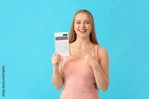 Young woman with calculator...