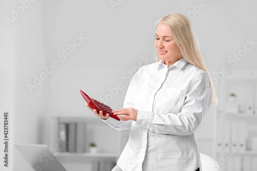 Mature accountant with calc...