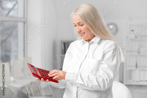 Mature accountant with calc...