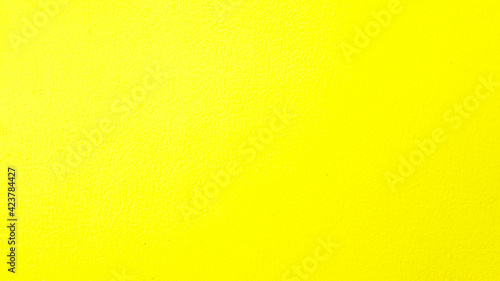 yellow painted wall for background. Colorful or pastel color of concrete wallpaper.