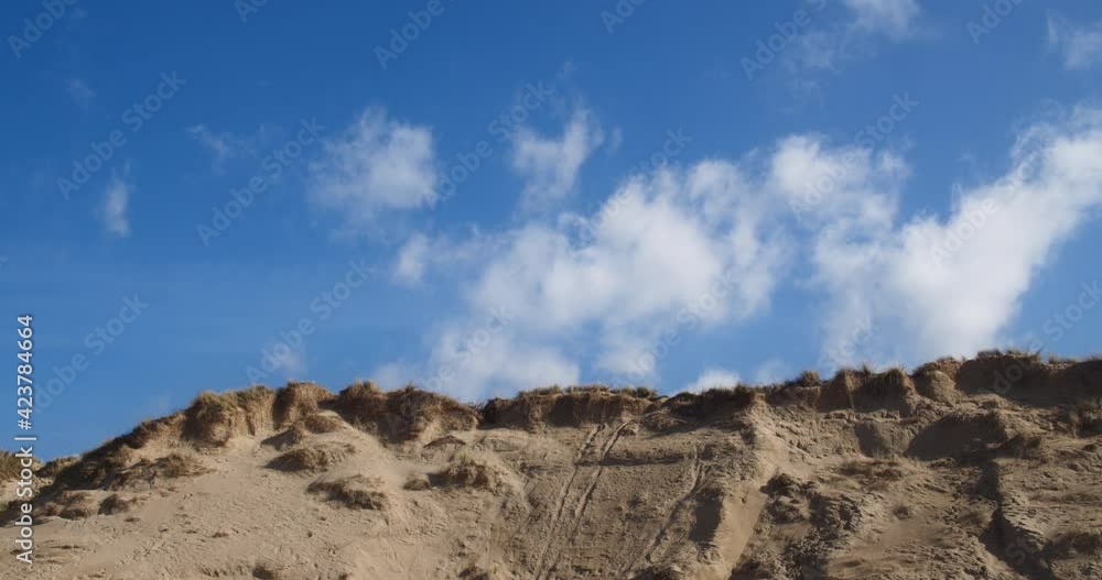 Time lapse of light clouds floating over sand dunes at Crantock Beach Time lapse of light clouds floating over sand dunes at Crantock Beach