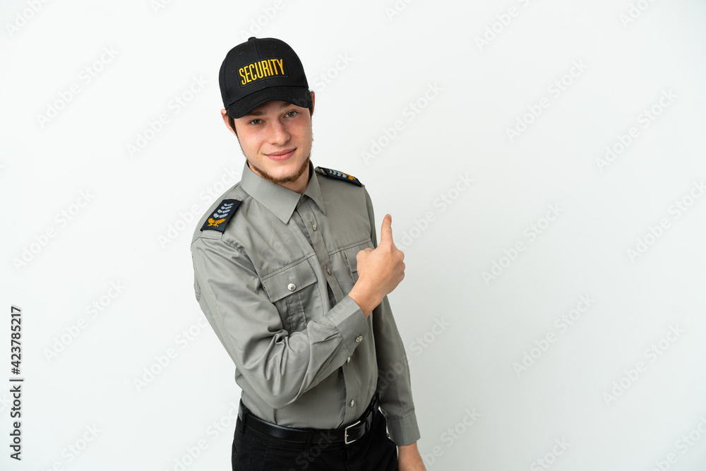Young Russian security man isolated on white background pointing back Young Russian security man isolated on white background pointing back