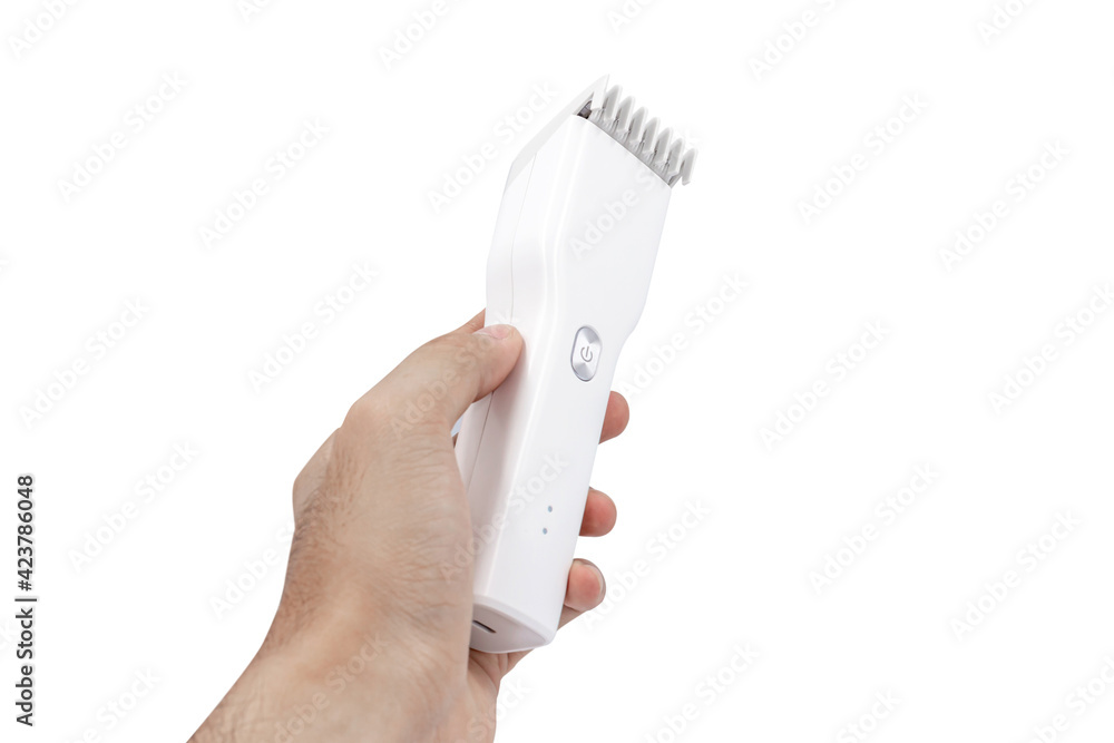 Hand holding white Cordless hair clipper isolated on white background Hand holding white Cordless hair clipper isolated on white background