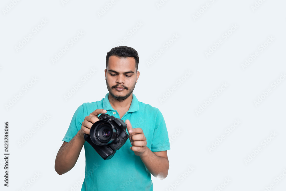 man with a professional DSLR camera, showing thumbs up, checking photos, showing the camera, operating the camera, with a blank white plate man with a professional DSLR camera, showing thumbs up, checking photos, showing the camera, operating the camera, with a blank white plate
