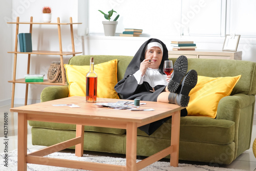 Senior nun with cigar and a...