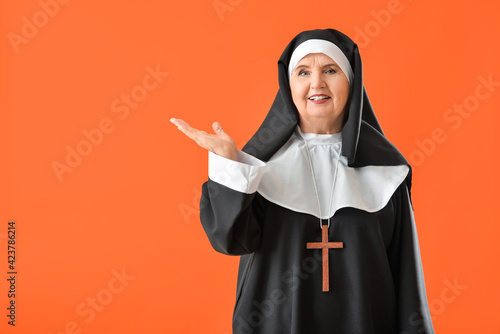 Senior nun showing somethin...