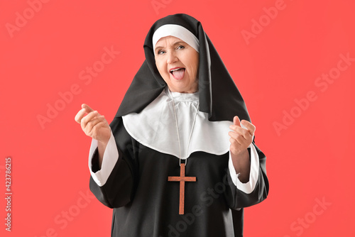 Funny senior nun on color b...