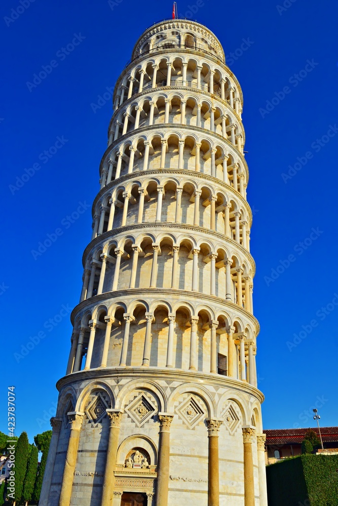 view of the Leaning Tower of Pisa on the Piazza del Duomo in the city of Pisa in Tuscany, Italy