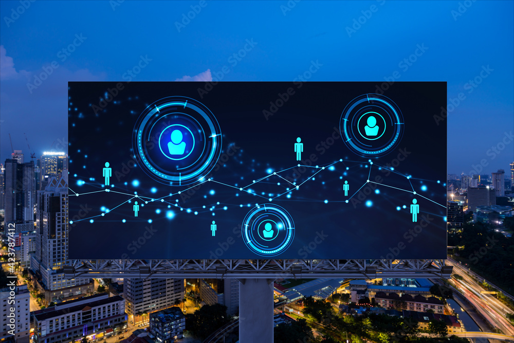 Fototapeta premium Glowing Social media icons on billboard over night panoramic city view of Kuala Lumpur, Malaysia, Asia. The concept of networking and establishing new connections between people and businesses in KL