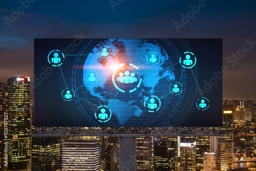World planet Earth map hologram and social media icons on billboard over night panoramic city view of Singapore, Southeast Asia. Networking and establishing new connections between people. Globe