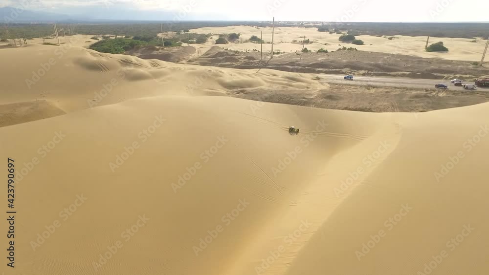 Drone shot of a Boogie car jumping the sand dunes in Medanos de Coro, Falcon, Venezuela. Drone shot of a Boogie car jumping the sand dunes in Medanos de Coro, Falcon, Venezuela.