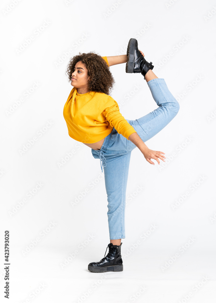 Young African American woman dancing over isolated white background Young African American woman dancing over isolated white background