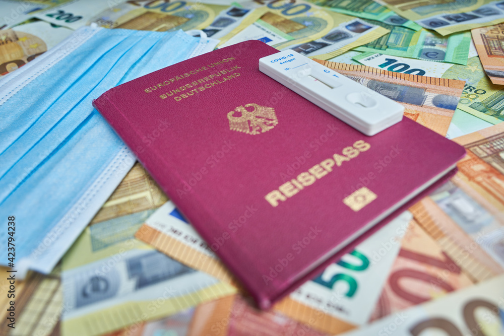 Covid-19 antigen rapid test cassette. Passport for the European Union. Medical mouth and nose mask on euro banknotes. Mandatory test for travel returnees. ( Testpflicht für Reiserückkehrer ) Covid-19 antigen rapid test cassette. Passport for the European Union. Medical mouth and nose mask on euro banknotes. Mandatory test for travel returnees. ( Testpflicht für Reiserückkehrer )
