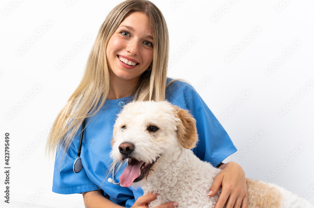 Young veterinarian woman with dog sitting on the floor Young veterinarian woman with dog sitting on the floor