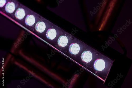 RGB lighting led equipment at the concert. Light and glare from a luminaire for shows and events. LED forstage professional lighting device colored.