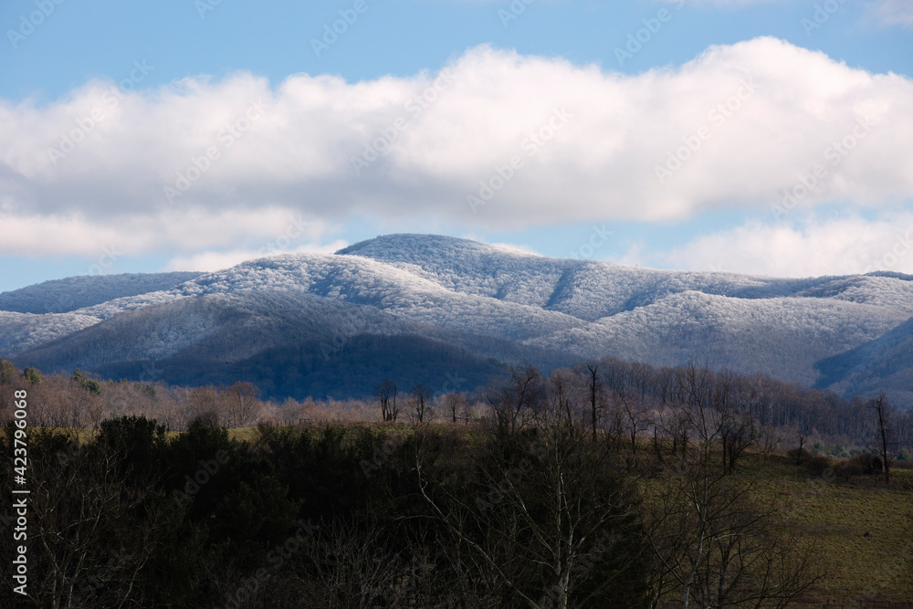 View of snow covered Appalachian Mountains under a blue sky in Virginia.