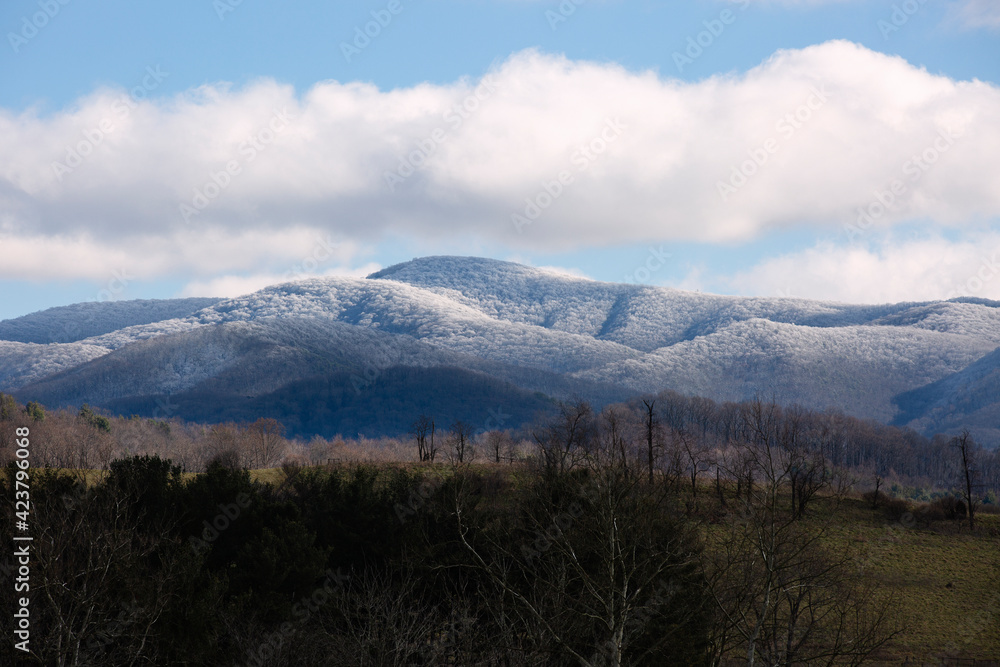 View of snow covered Appalachian Mountains under a blue sky in Virginia. View of snow covered Appalachian Mountains under a blue sky in Virginia.