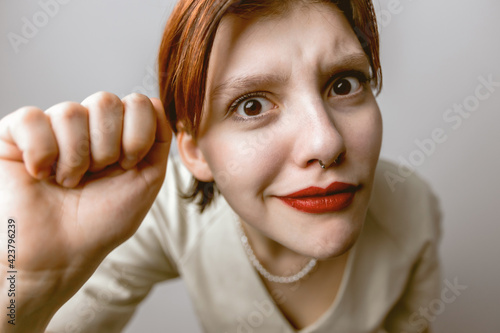 Girl knocking on the camera, distorted portrait