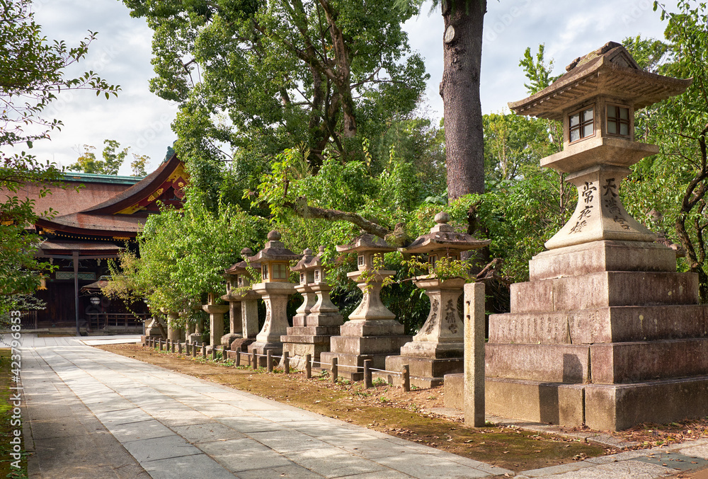 A kaku-doro (square) stone lanterns along the pass at Kitano Tenmangu shrine. Kyoto. Japan A kaku-doro (square) stone lanterns along the pass at Kitano Tenmangu shrine. Kyoto. Japan
