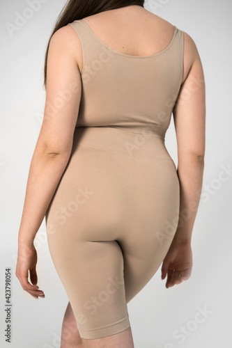 Overweight woman with full hips posing at the studio