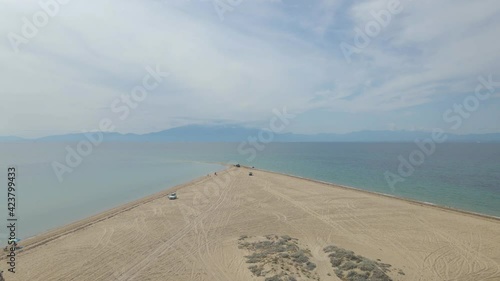 4k taking off clip over a peninsula on  the tropical beach of Epanomi, Halkidiki, Greece photo