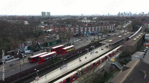 LOCKDOWN VIEW OF LONDON SUBURB TRAIN STATION AERIAL photo