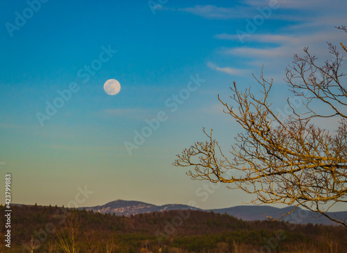 full moon rising on a Vermont landscape 